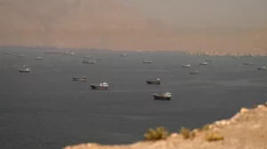 Commercial ships sailing through the Strait of Hormuz amid US-Iran tensions.