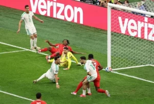 Algeria national football team players in green kits challenge Switzerland during their FIFA World Cup 2026 Round of 32 match in Vancouver.