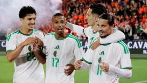 Algeria national football team players in green kits challenge Switzerland during their FIFA World Cup 2026 Round of 32 match in Vancouver.
