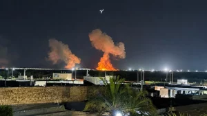 Smoke rises following reported US strikes on targets in Iran amid escalating Strait of Hormuz tensions.
