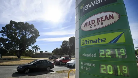 Australia diesel prices record high 2026 motorist filling up at a petrol station amid fuel crisis and Easter travel disruption caused by Iran war