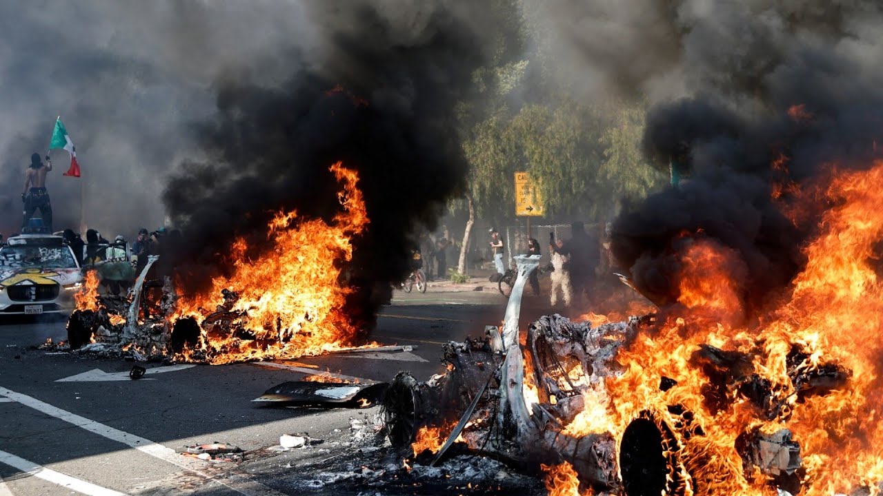 Protesters clashing with law enforcement in a US city street during 2025 political unrest"