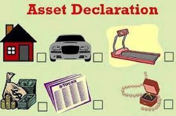 Pakistani civil servants submitting asset declaration forms at government office under IMF-mandated transparency reforms 2026