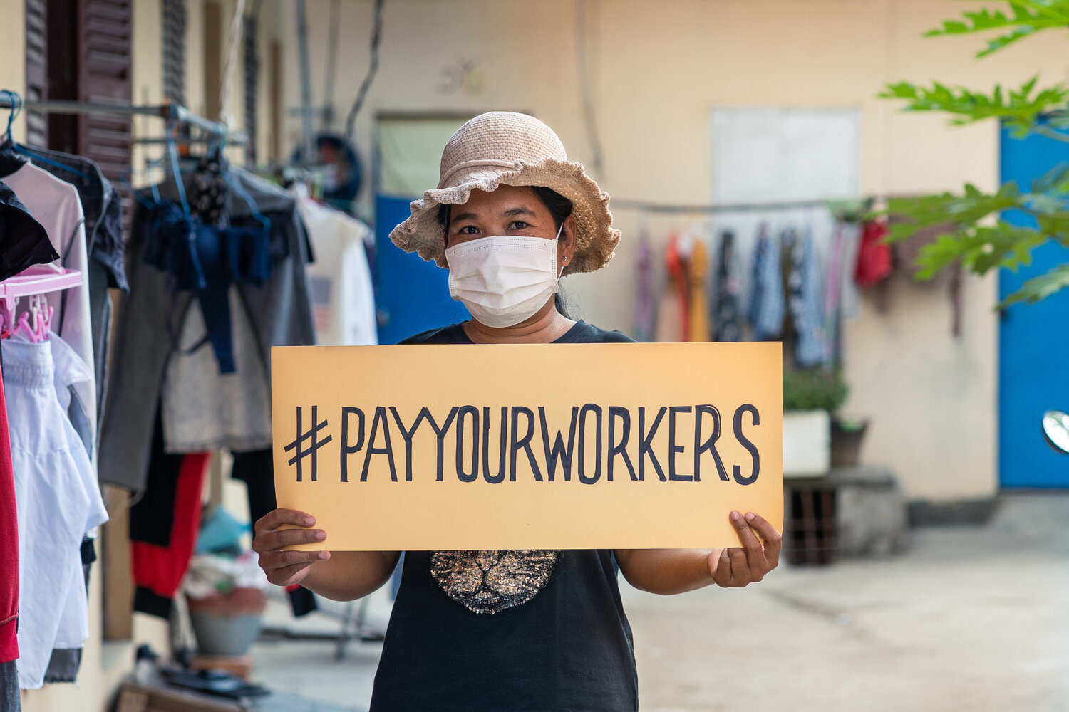 A factory worker in unsafe conditions representing global labour exploitation and workers' rights violations