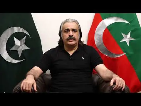 Ali Amin Gandapur standing at a PTI political gathering in Khyber Pakhtunkhwa, wearing traditional Pashtun attire