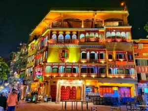 Fort Road Food Street Lahore at night with view of Badshahi Mosque and illuminated Mughal-era havelis