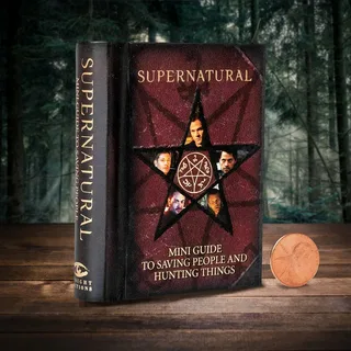 Open book with dark atmospheric lighting surrounded by fog and candles, representing best supernatural short stories collection 2026
