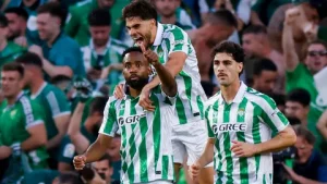 Real Betis players celebrating UEFA Champions League qualification 2026 after defeating Elche at Benito Villamarin Stadium