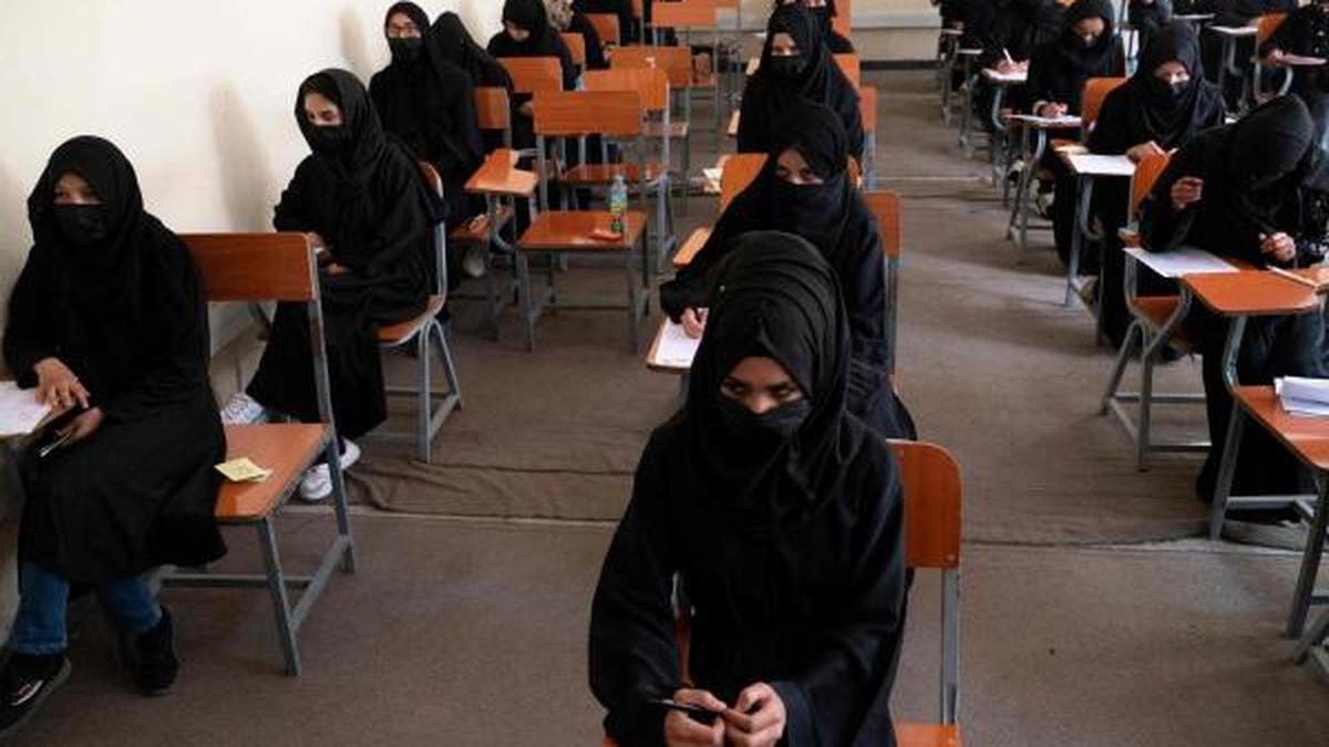 Afghan refugee girls in Pakistan sitting in an informal classroom, facing deportation back to Taliban-ruled Afghanistan where the women education crisis has banned girls from schools above grade 6