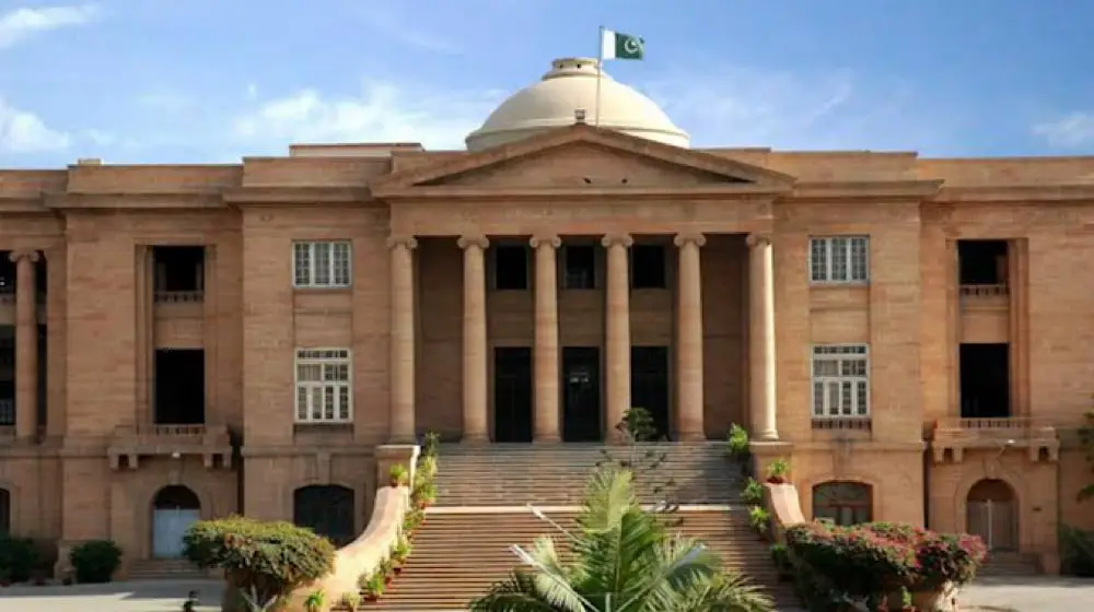 Sindh High Court building in Karachi with legal gavel representing SHC case search and TRG shareholding dispute ruling