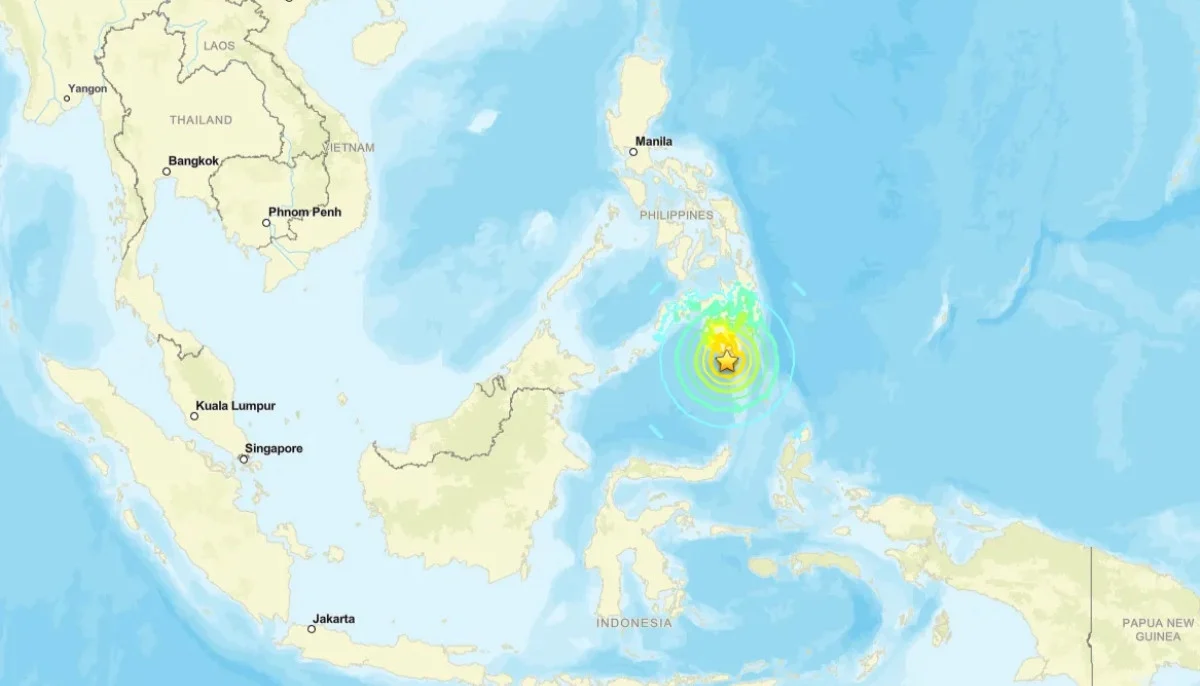 Map of Asia and Pacific showing tsunami alert zones after an 8.2 magnitude earthquake near the Philippines with emergency warning indicators displayed.