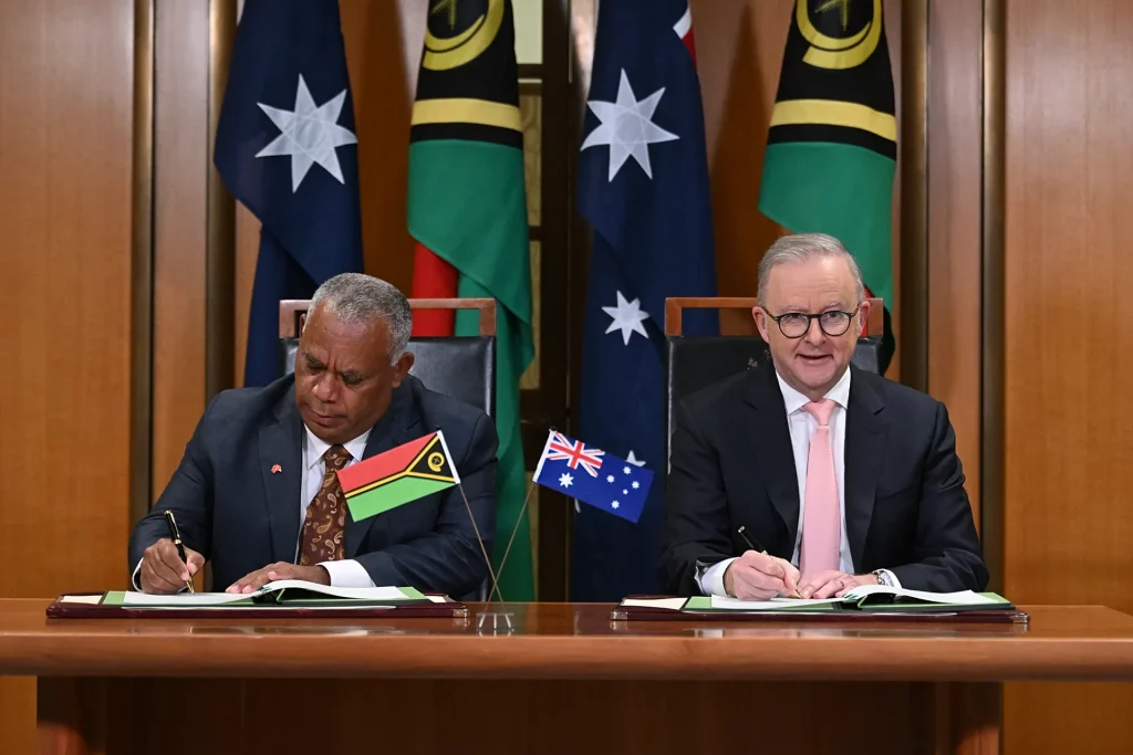Australian Prime Minister and Vanuatu Prime Minister shake hands after signing the Pukpuk Treaty to strengthen Pacific security cooperation.