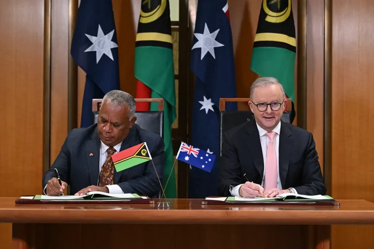 Australian Prime Minister and Vanuatu Prime Minister shake hands after signing the Pukpuk Treaty to strengthen Pacific security cooperation.