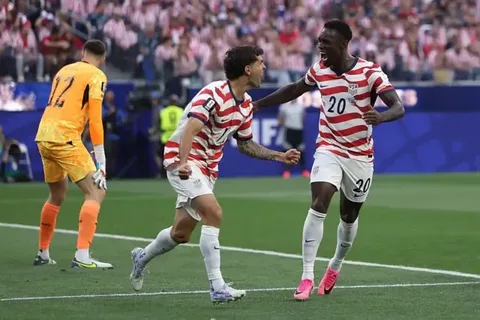 USA and Paraguay players competing during a FIFA World Cup 2026 match as fans celebrate goals and key moments