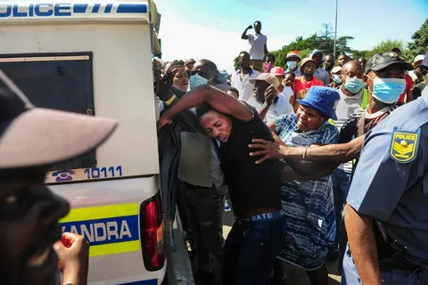 Foreign nationals gathered outside a Johannesburg market during rising xenophobia in South Africa 2026.