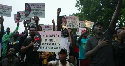 Citizens and civil society activists in Ghana discussing free speech, democracy, and human rights issues during a public gathering.