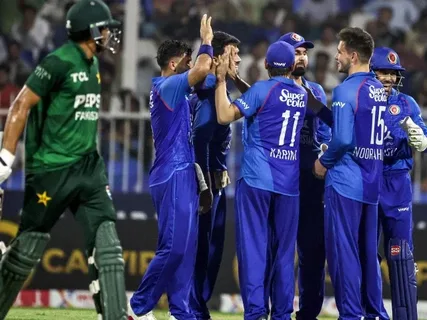 Pakistan and Afghanistan cricket teams competing in an intense Asian Games match during a closely fought T20 encounter.