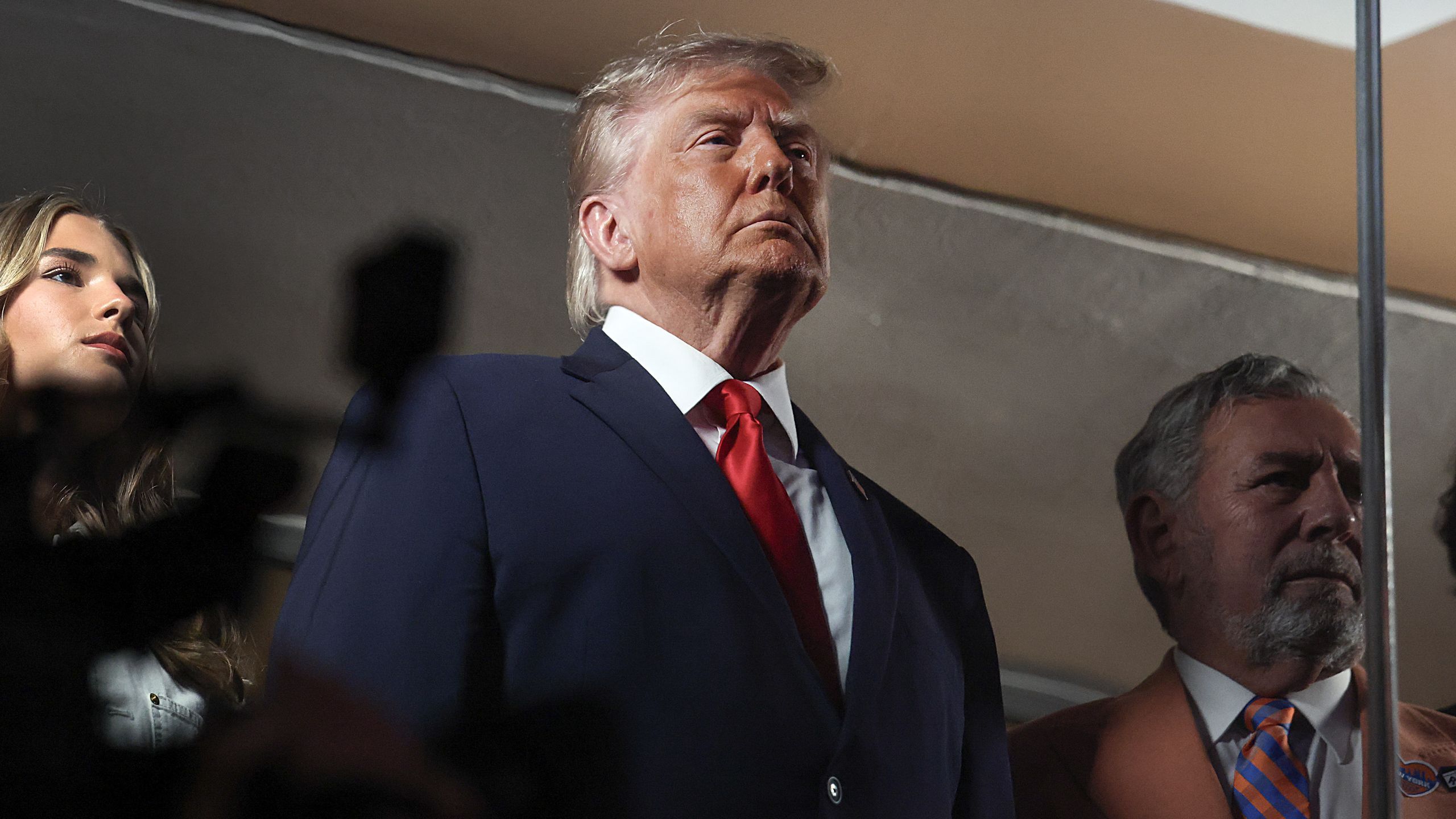 Donald Trump watching the Knicks vs Spurs Game 2 while fans react inside the arena