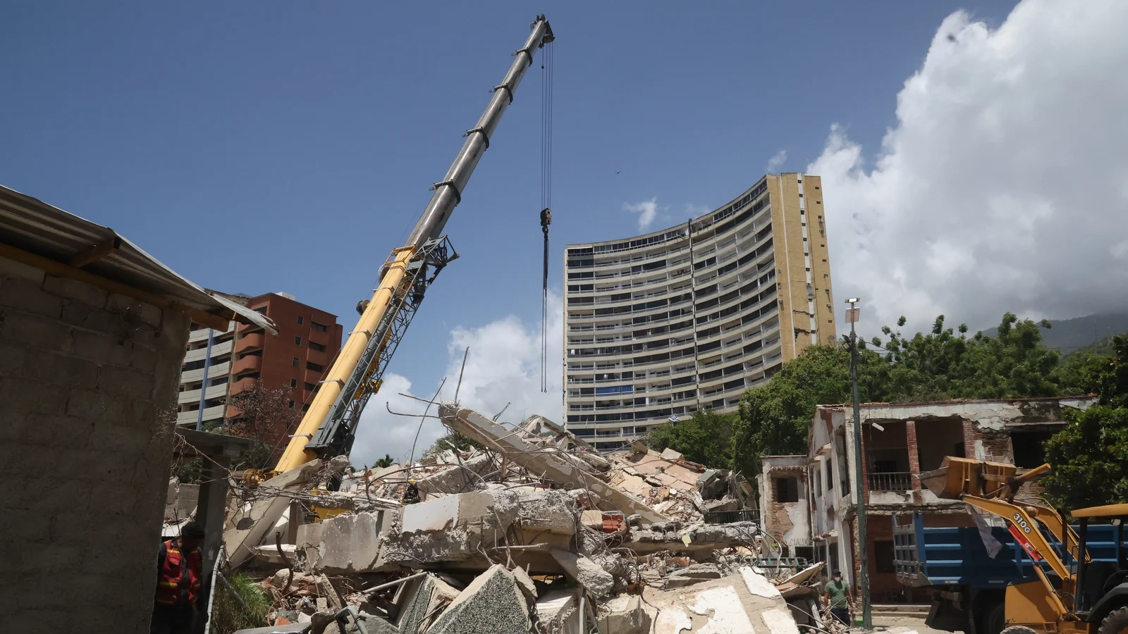 Rescue workers searching through debris after the Venezuela earthquake as survivors await humanitarian aid