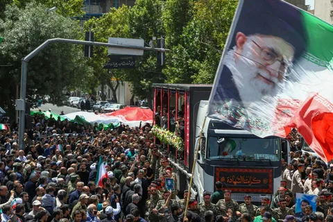 Mourners gather in Tehran beside the flag-draped coffin of Ayatollah Ali Khamenei during Iran's state funeral procession.