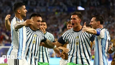 Players celebrating a goal during FIFA World Cup 2026 Round of 32 match under stadium lights