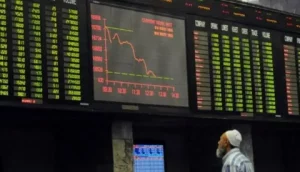 Pakistan Stock Exchange Today trading floor showing KSE-100 index falling on digital screens in Karachi