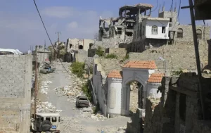 Damaged home standing beside inhabited house on Taiz front line in Yemen