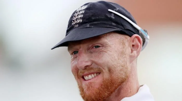 Ben Stokes speaks to England teammates in the dressing room before announcing his Test retirement.