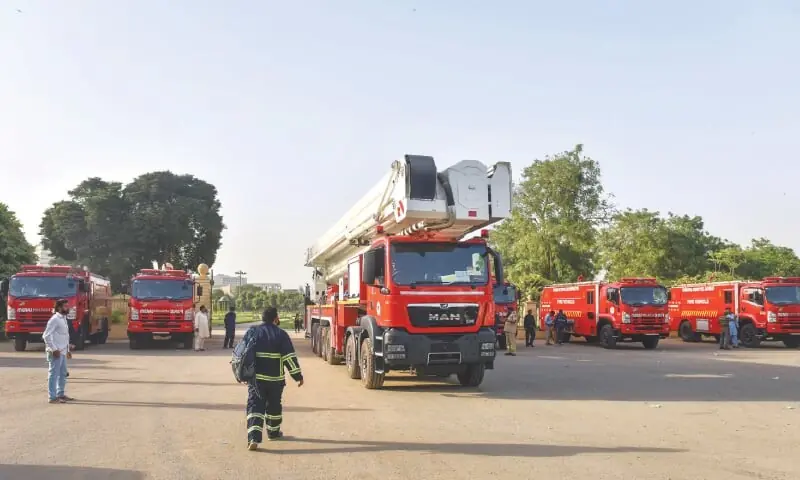 Firefighters and hospital staff outside a Punjab government hospital during a fire-safety inspection