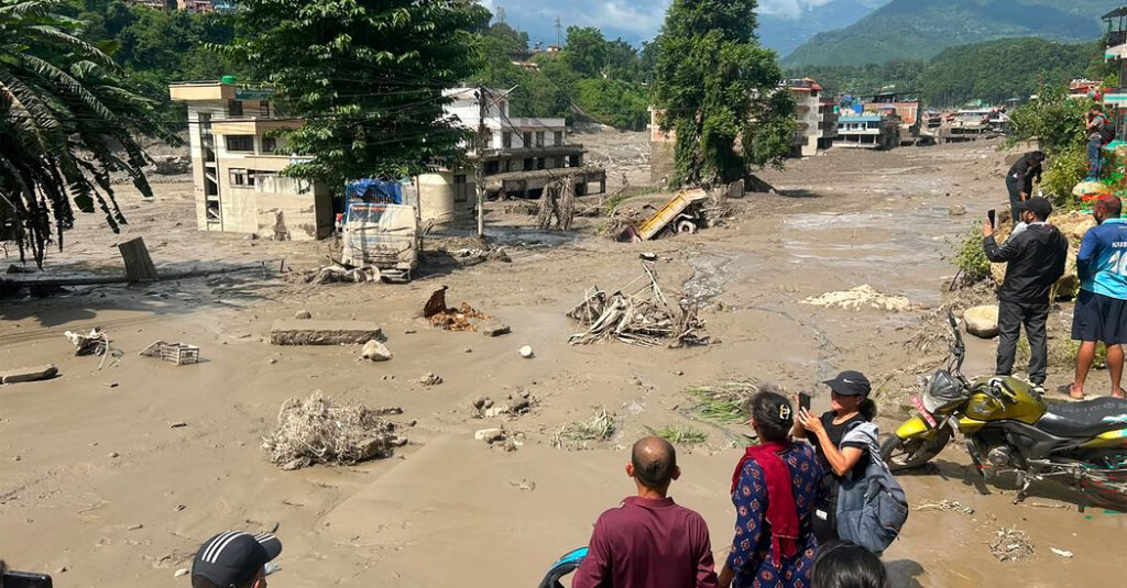 Rescue workers searching through thick mud and debris after the Nepal-China border flash flood in Rasuwa district