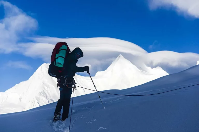 Rescue team climbing snow-covered Spantik peak during recovery mission in Karakoram range, Pakistan