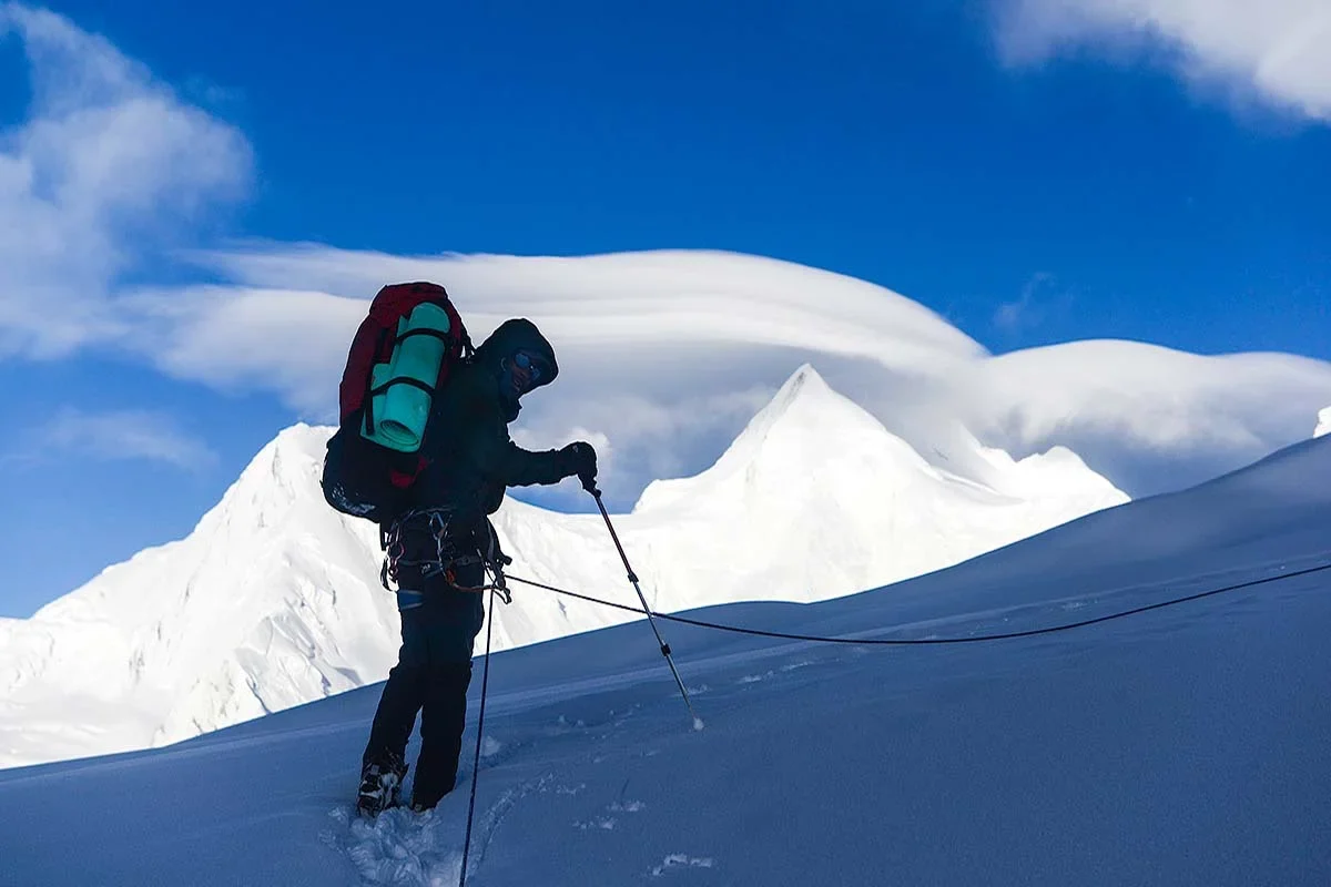 Rescue team climbing snow-covered Spantik peak during recovery mission in Karakoram range, Pakistan