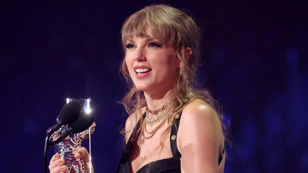 Taylor Swift performing on stage during the Eras Tour, celebrating ownership of her masters