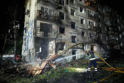 Emergency responders work at a damaged site in Kyiv following a Russian missile attack during the Russia-Ukraine war.