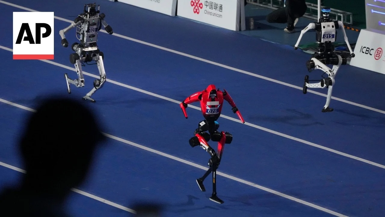 Humanoid robots competing in the 100m sprint at the World Humanoid Robot Games opening ceremony in Beijing, August 2026