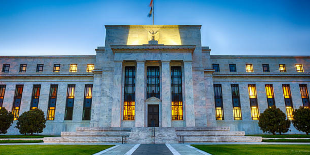US Federal Reserve building with a rising interest rate chart overlay, symbolizing the Fed hawkish turn