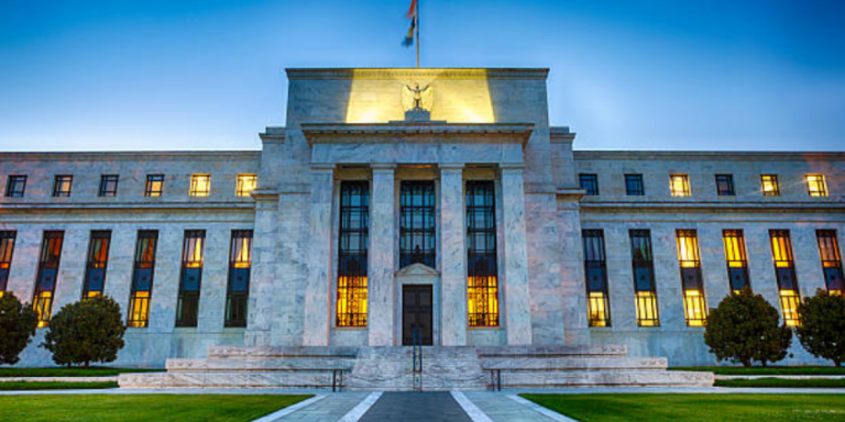 US Federal Reserve building with a rising interest rate chart overlay, symbolizing the Fed hawkish turn