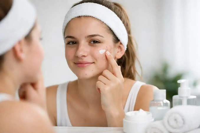 Teenager following a skincare routine with beauty products