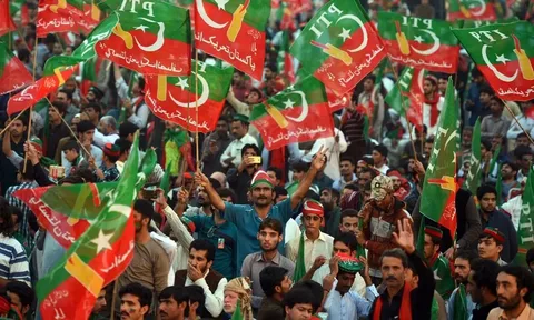 PTI supporters with party flags gathering for the long march in Khyber Pakhtunkhwa, with caravans heading from Lakki Marwat toward Peshawar